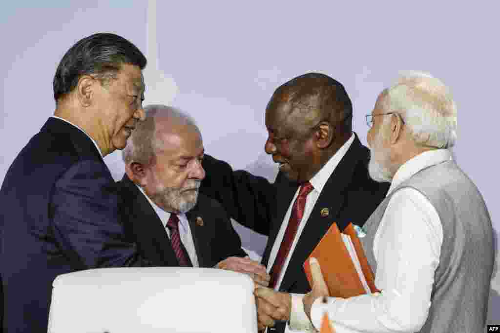 President of China Xi Jinping, President of Brazil Luiz Inacio Lula da Silva, South African President Cyril Ramaphosa and Prime Minister of India Narendra Modi gesture during the 2023 BRICS Summit at the Sandton Convention Centre in Johannesburg.