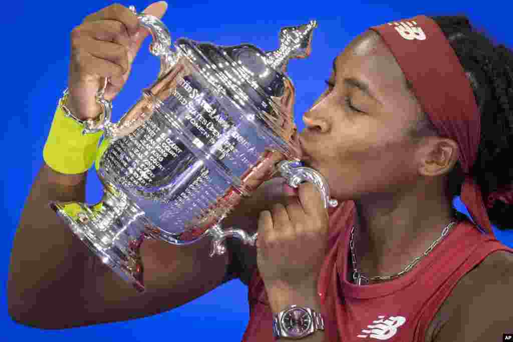 Coco Gauff of the United States poses for photographs after defeating Aryna Sabalenka of Belarus at the women's singles final of the U.S. Open tennis championships, Sept. 9, 2023, in New York.