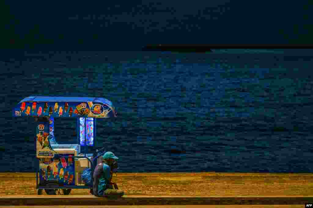 A vendor selling ice cream waits for customers at the Galle Face Beach in Colombo. Cash-strapped Sri Lanka is seeking a 10-year moratorium on its foreign debt, President Ranil Wickremesinghe's office said.