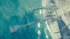 FILE - This image provided by U.S. Central Command shows U.S. and Israeli military personnel placing a floating pier on the coast of the Gaza Strip on May 16, 2024. U.S. officials announced June 28 that the pier had been detached and was being moved because of rough seas.