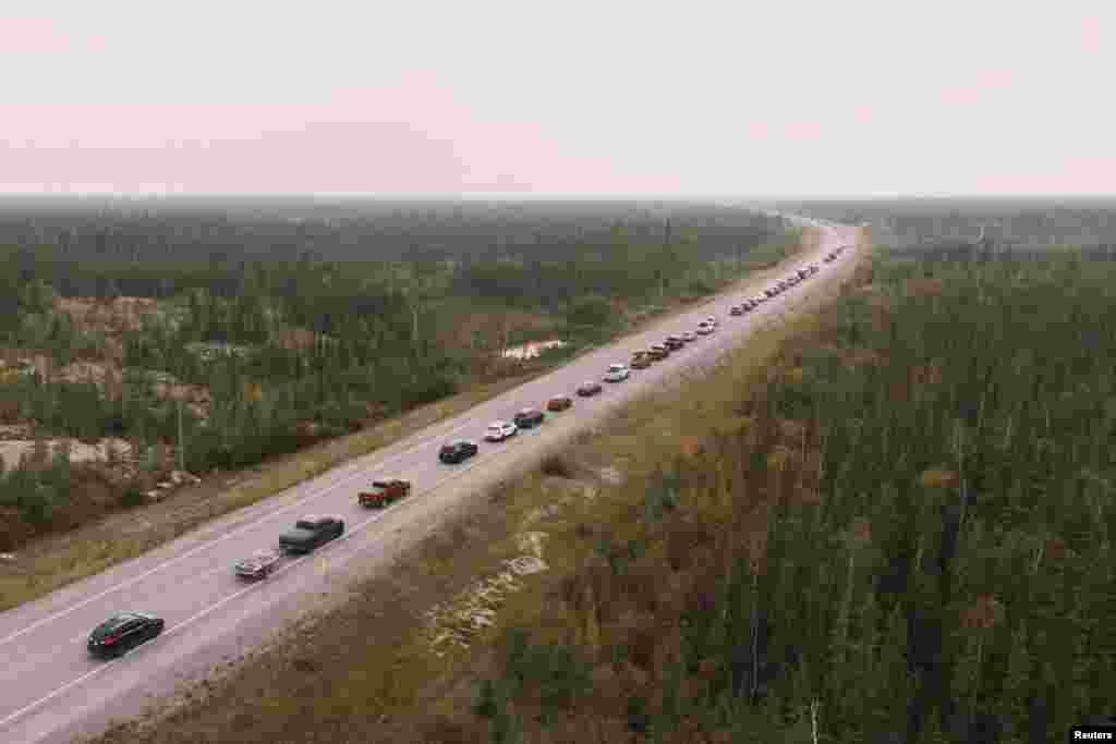Yellowknife residents leave the city on Highway 3, the only highway in or out of the community, after an evacuation order was given due to the proximity of a wildfire in Yellowknife, Northwest Territories, Canada, Aug. 16, 2023.