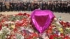 FILE - A group of ambassadors of foreign diplomatic missions visit a makeshift memorial in front of Crocus City Hall, site of a March 22, 2024, terror attack, on the outskirts of Moscow, Russia, March 30, 2024. 