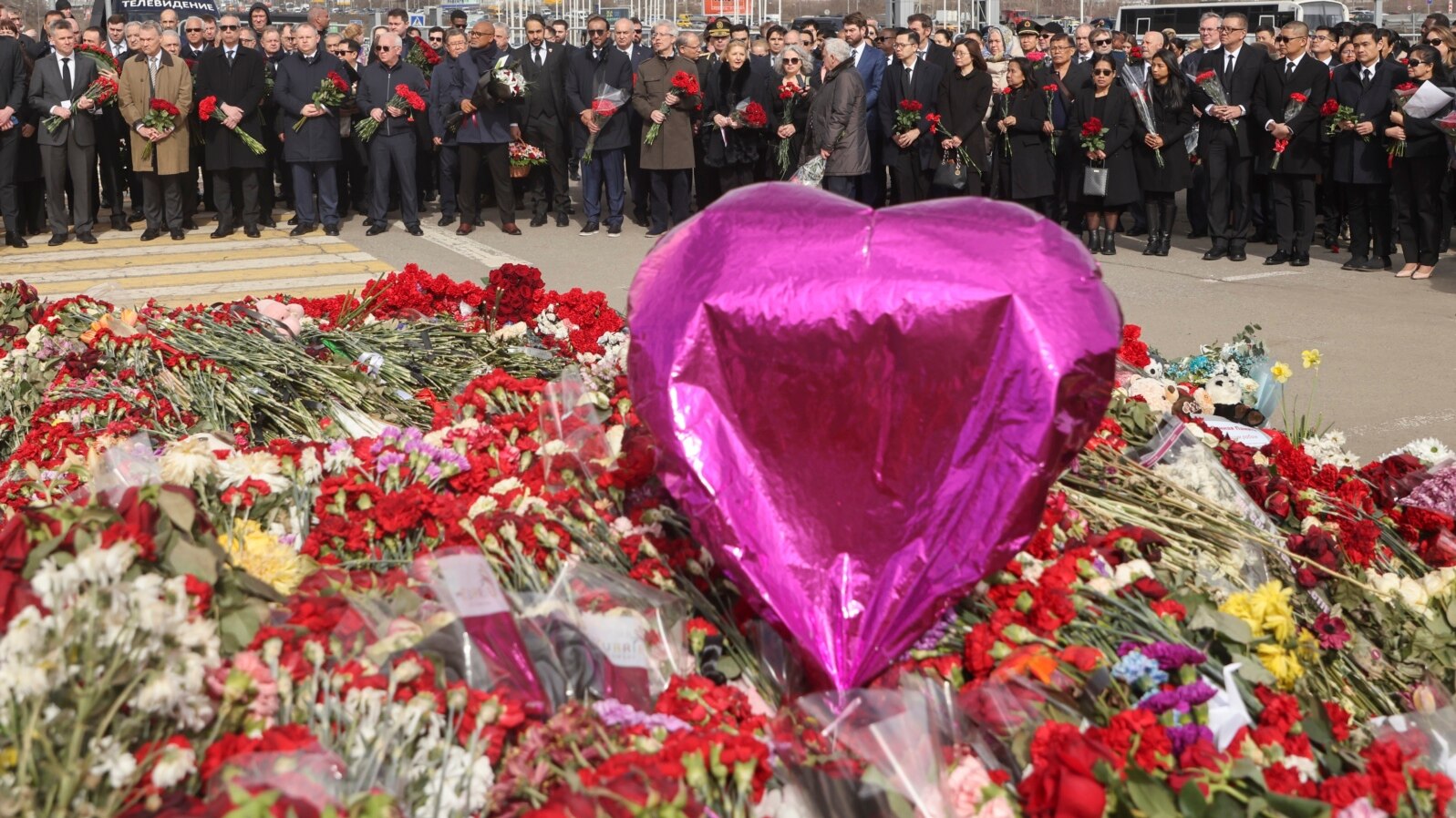 FILE - A group of ambassadors of foreign diplomatic missions visit a makeshift memorial in front of Crocus City Hall, site of a March 22, 2024, terror attack, on the outskirts of Moscow, Russia, March 30, 2024. 
