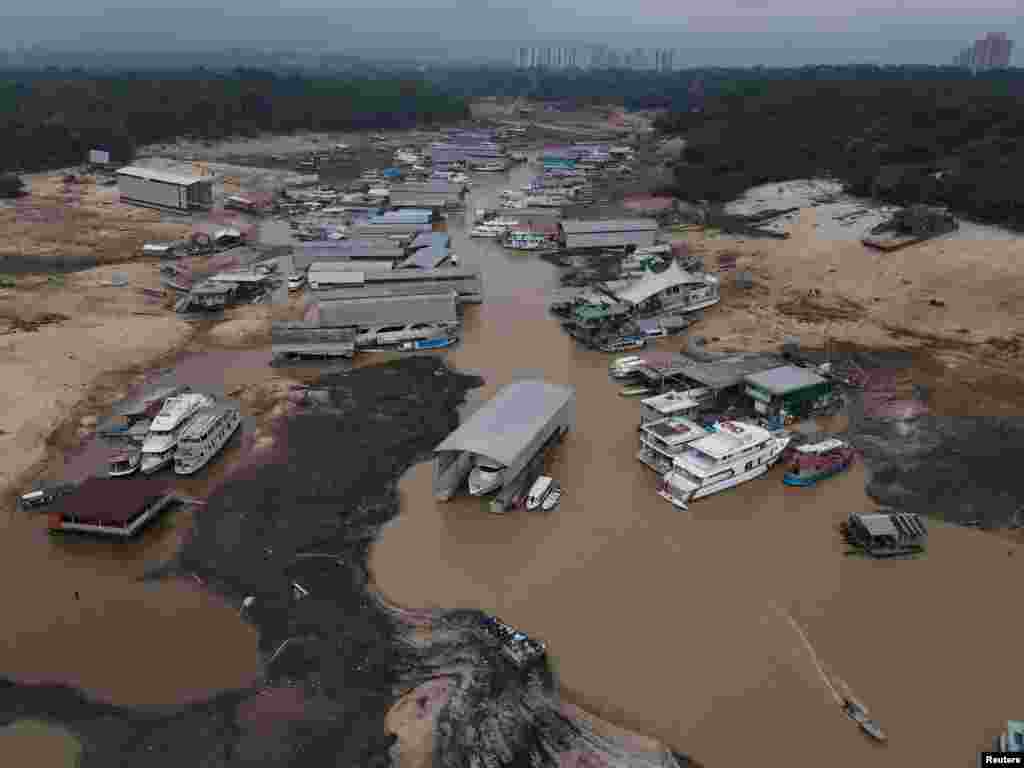 Boats and houseboats are seen stranded at David's Marina as the water level at a major river port in Brazil's Amazon rainforest hit its lowest point in at least 121 years, at the Rio Negro river in Manaus, Oct. 16, 2023.