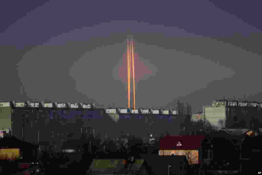 Three rockets launched against Ukraine from Russia's Belgorod region are seen at dawn in Kharkiv, Ukraine.