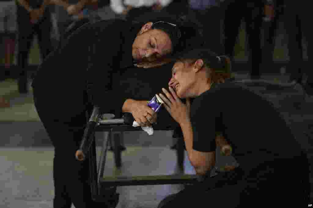 Mourners grieve beside the body of Mapal Adam, during her funeral in Tel Aviv, Israel. Adam was killed by Hamas militants on Oct. 7 as they carried out an unprecedented, multi-front attack that killed over 1,000 Israelis.