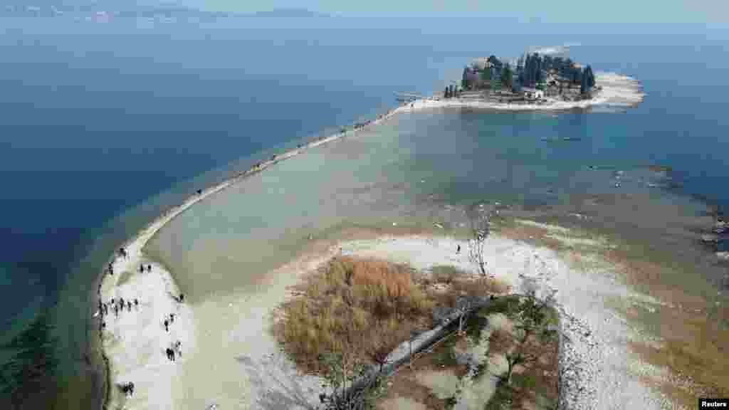 A drone image shows San Biagio island, affected by drought in Lake Garda, near Lido di Manerba, Italy, Feb. 21, 2023.