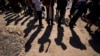 FILE - Migrants wait to be processed after entering the U.S. from Mexico in Eagle Pass, Texas, Oct. 19, 2023. Changes in global migration patterns and smuggling routes have created an opening for terror groups to set their sights on the U.S. southern border. 