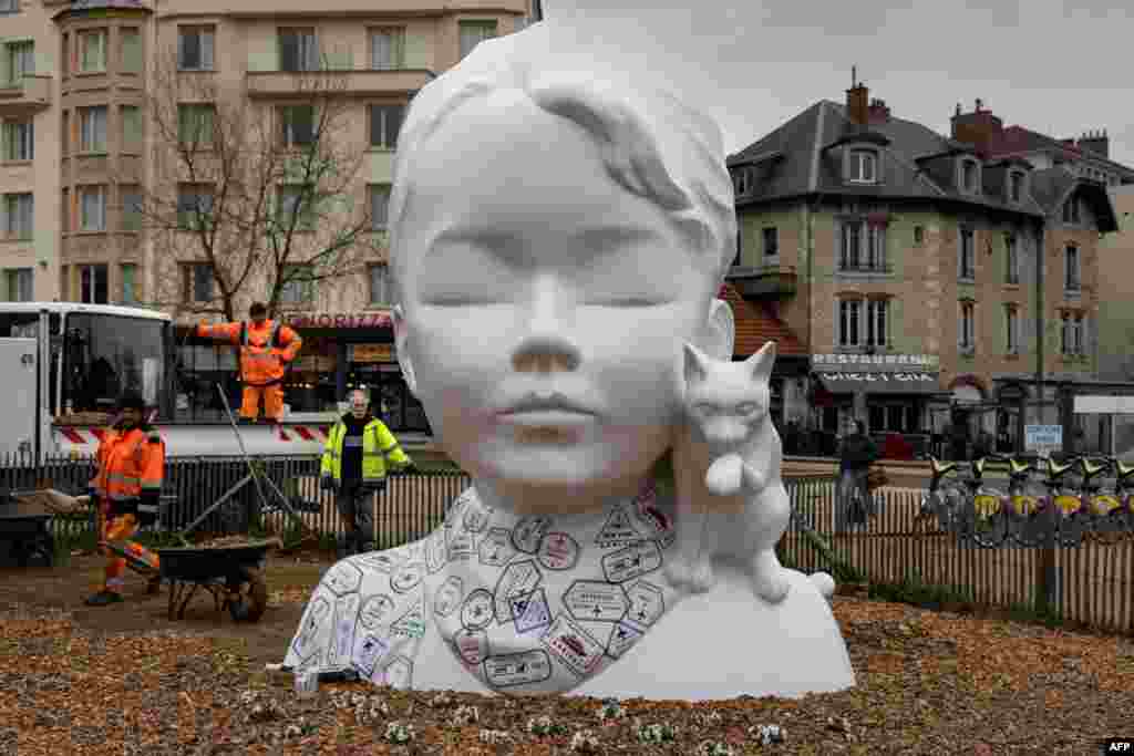 City employees prepare the inauguration of the sculpture entitled &quot;The human face has always been my great landscape&quot; by French artist Nathalie Talec in Besançon, France.