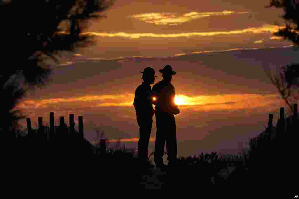 Delaware State Troopers secure the area at sunrise before President Joe Biden boards Marine One at Gordons Pond State Park in Rehoboth Beach, Delaware.