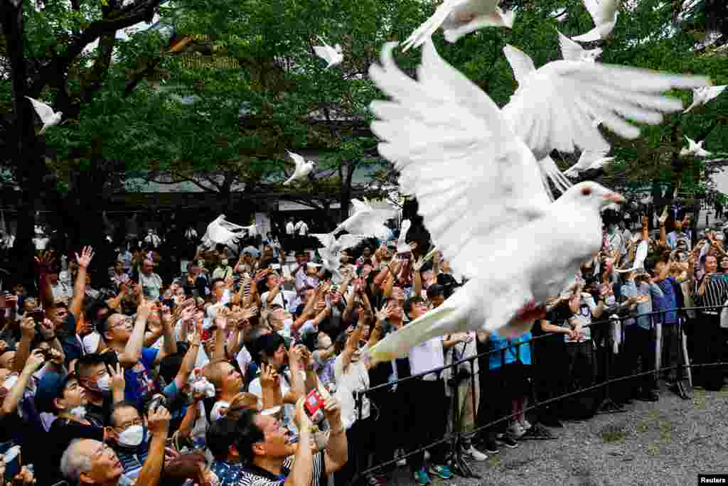 People release doves during their visit to the Yasukuni Shrine on the 78th anniversary of Japan's surrender in World War II, in Tokyo.