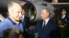 Russian President Vladimir Putin, right, greets Artem Dultsev, left, upon arrival of freed Russian prisoners at Vnukovo government airport outside Moscow, Aug. 1, 2024. (Mikhail Voskresensky, Sputnik, Kremlin pool photo via AP)