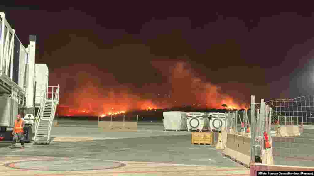 A wildfire burns near the Sicilian airport "Falcone-Borsellino" in Punta Raisi near Palermo, Italy.