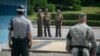 판문점 공동경비구역(JSA) 내 북한 군 장병들(가운데)이 미군과 한국군 장병을 촬영하고 있다. (자료사진)
