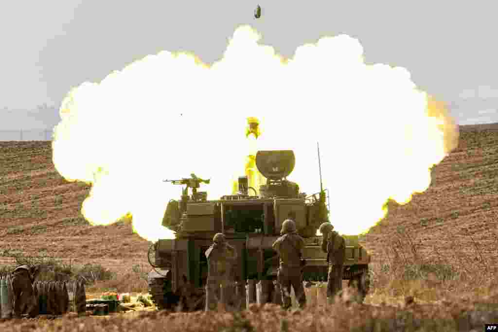 An Israeli army self-propelled howitzer fires rounds near the border with Gaza in southern Israel. Israel declared war on Hamas on October 8 following a shock land, air, and sea assault by the Gaza-based militant group. 
