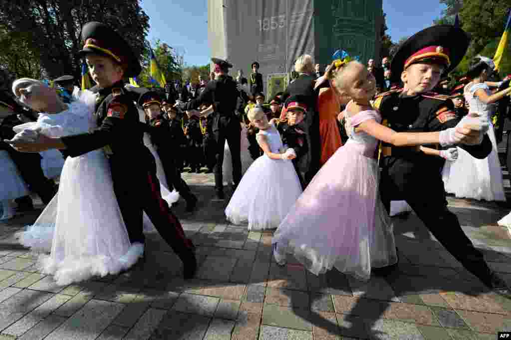 Young Ukrainian cadets of Kyiv's "Cadets Corp" military school dance after the graduation ceremony at the Monument to Prince Volodymyr in Kyiv, amid Russian invasion of Ukraine.