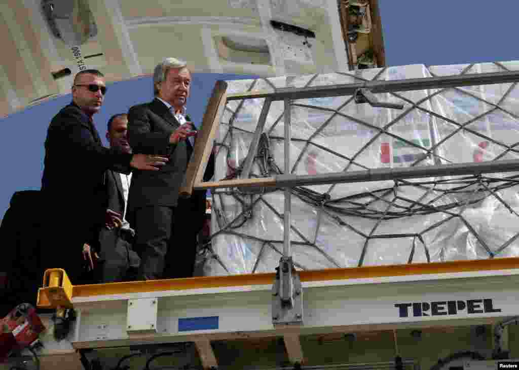 United Nations Secretary-General Antonio Guterres inspects aid for Palestinians, as officials wait to deliver aid to Gaza through the Rafah border crossing between Egypt and the Gaza Strip, at Al Arish airport, in Egypt.