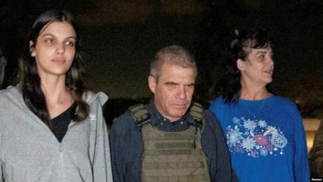Judith Tai Raanan and daughter Natalie Shoshana Raanan, U.S. citizens who were Hamas hostages, walk with retired Brig. Gen. Gal Hirsch, Israel's coordinator for the captives and missing, after their release, in this handout picture, Oct. 20, 2023.