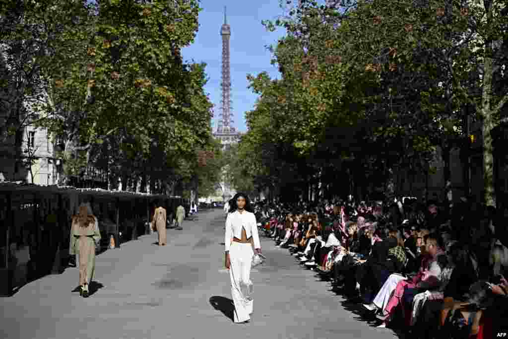 Models present creations by British designer Stella McCartney during her show next to the Eiffel Tower as part of the Womenswear Spring/Summer 2024 Paris Fashion Week in Paris, France.
