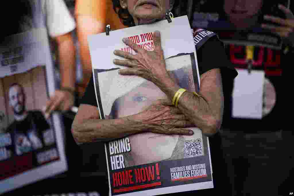 Relatives and friends of those kidnapped during the October 7 Hamas cross-border attack in Israel hold photos of their loved ones during a protest calling for their return outside the Knesset, Israel's parliament in Jerusalem. On October 7, about 240 were taken hostage and 1,400 were killed in the attack by Hamas militants in Israel. 