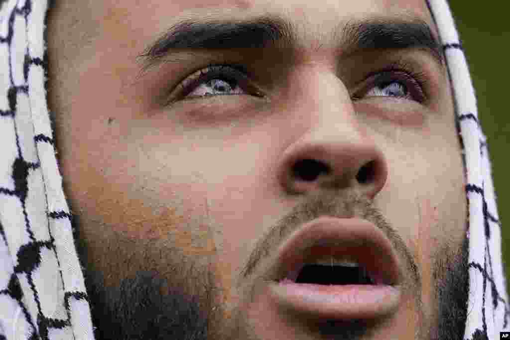 A Muslim community member mourns Wadea Al Fayoume at his grave in LaGrange, Illinois, Oct. 16, 2023. An Illinois landlord accused of fatally stabbing the six-year-old Muslim boy and seriously wounding his mother was charged with a hate crime after police and relatives said he singled out the victims because of their faith and as a response to the war between Israel and Hamas. 