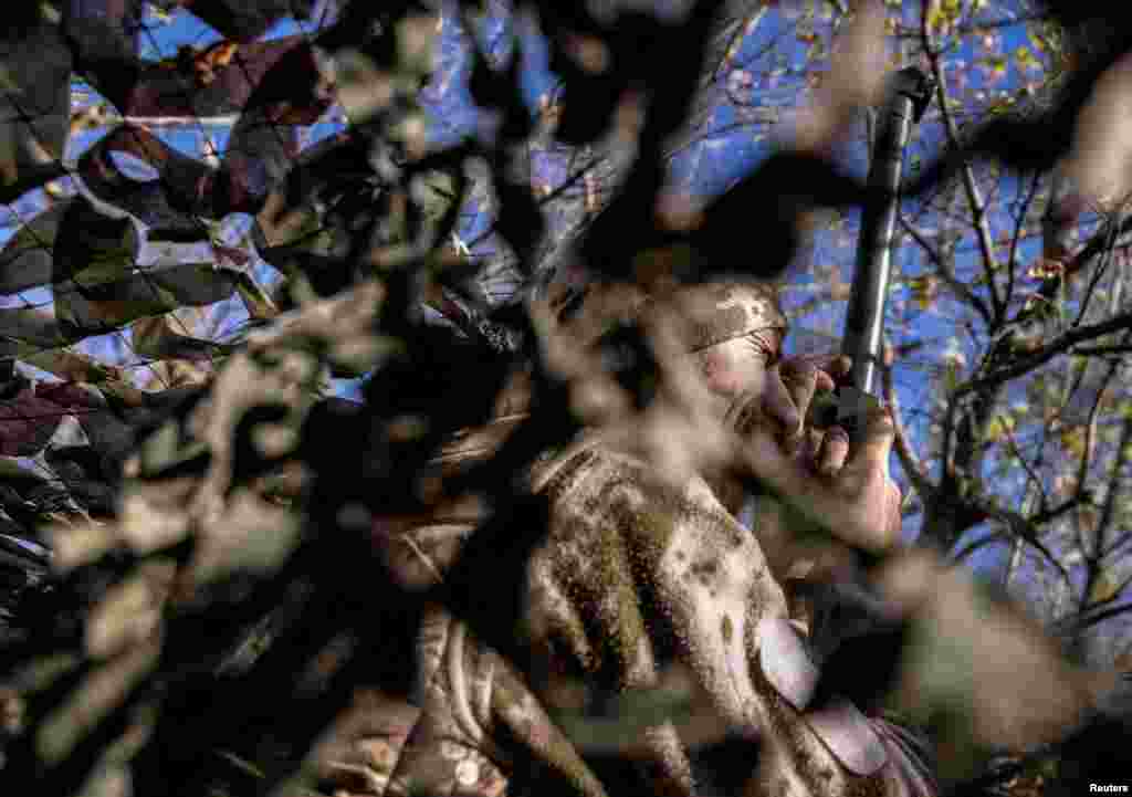 A Ukrainian serviceman observes an area at a position near a frontline, amid Russia&#39;s attack on Ukraine, in Donetsk region, Oct. 15, 2023.