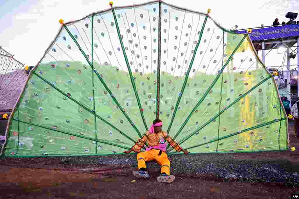 A man rests after performing a traditional dance during a ceremony at the Tazaungdaing festival, also known as the Festival of Lights, in Taunggyi in Myanmar's Shan State, Nov. 21, 2023.