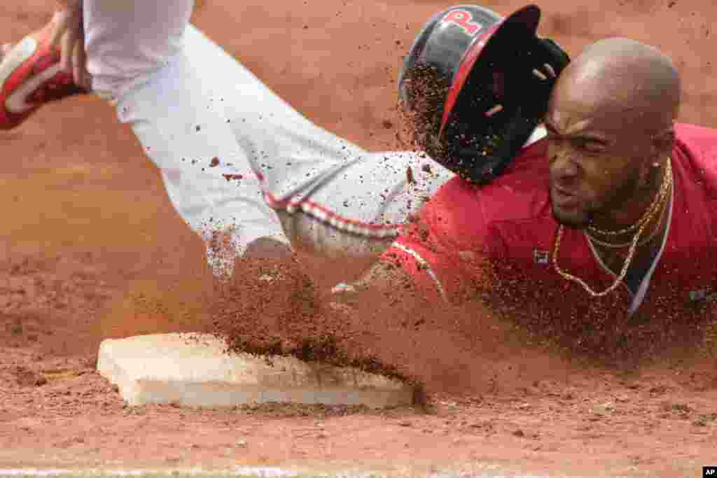 Panama's Edgar Munoz slides safely to first after batting during a baseball game against Mexico at the Pan American Games in Santiago, Chile. Panama won 8-2. 