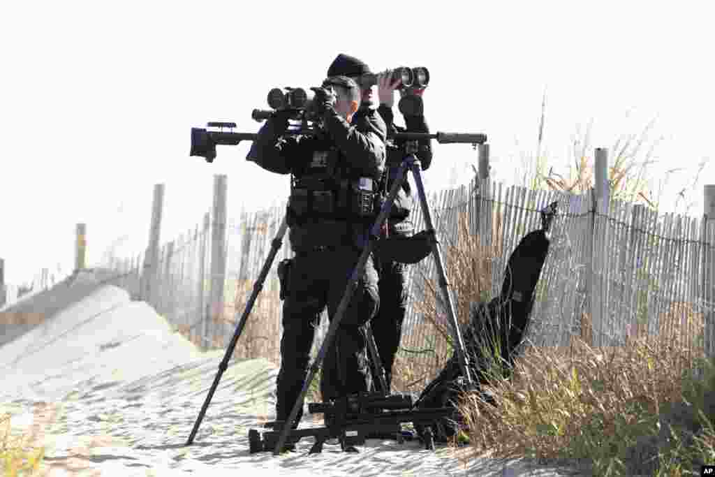 Members of the U.S. Secret Service Counter Sniper Team secure the perimeter as the motorcade of President Joe Biden arrives at Gordons Pond State Park in Rehoboth Beach, Delaware.
