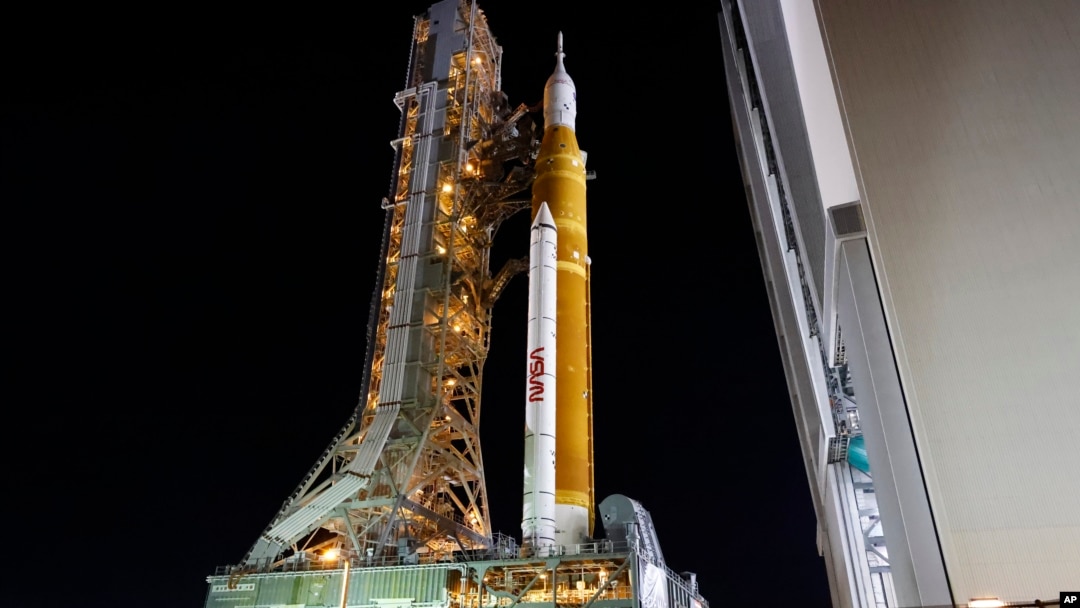 The NASA Artemis rocket with the Orion spacecraft aboard leaves the Vehicle Assembly Building moving slowly to pad 39B at the Kennedy Space Center in Cape Canaveral, Fla., Tuesday, Aug. 16, 2022. (AP Photo/Terry Renna)