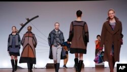FILE - Models wear creations for Issey Miyake's ready to wear fall/winter 2014-2015 fashion collection presented in Paris, Feb.28, 2014.
