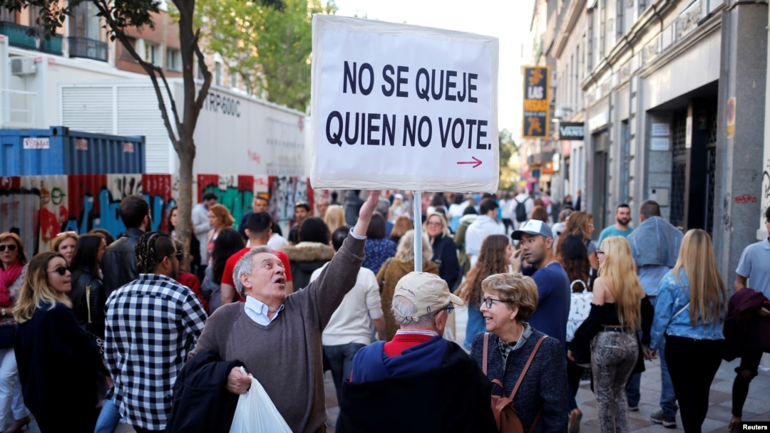 Martin Sagrera, 83, Catalonian retiree living in Madrid, holds a sign that reads "Don't complain if you don't vote" ahead of the April 28 Spanish general election, in downtown Madrid, April 27, 2019.