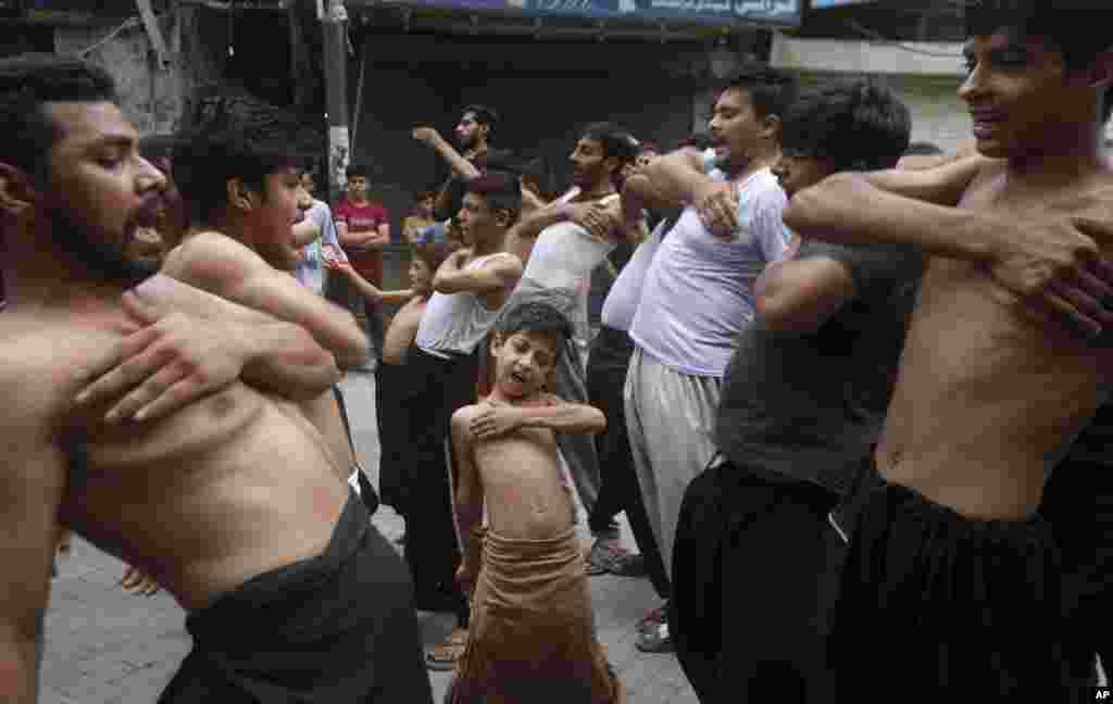 A Shi'ite Muslim boy beat his chest with others during a Muharram procession, in Lahore, Pakistan.