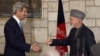 U.S. Secretary of State John Kerry (L) and Afghanistan's President Hamid Karzai shake hands at the end of their joint news conference at the presidential palace in Kabul, March 25, 2013. 
