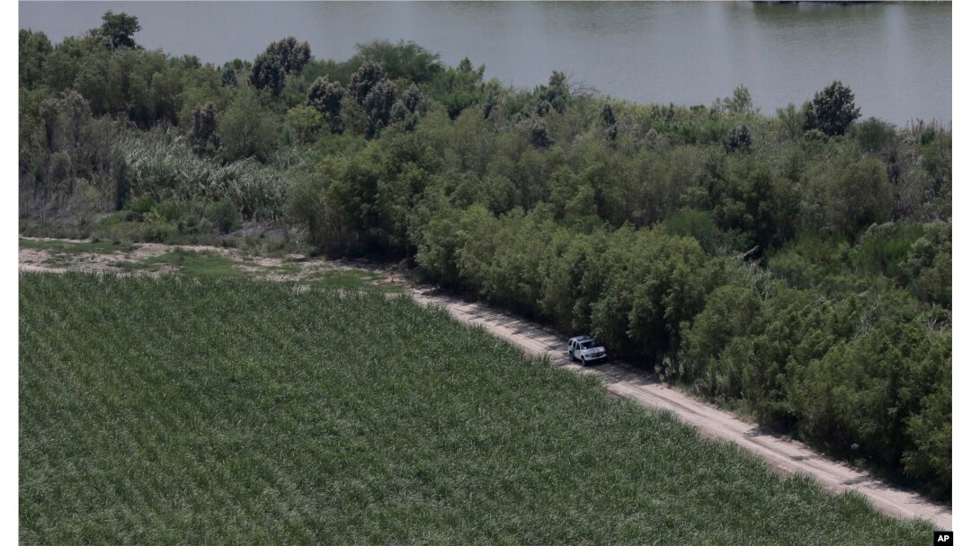 FILE - In this July 24, 2014, photo, a Customs and Border Protection vehicle patrols on the Texas border near the Rio Grande in Mission, Texas.