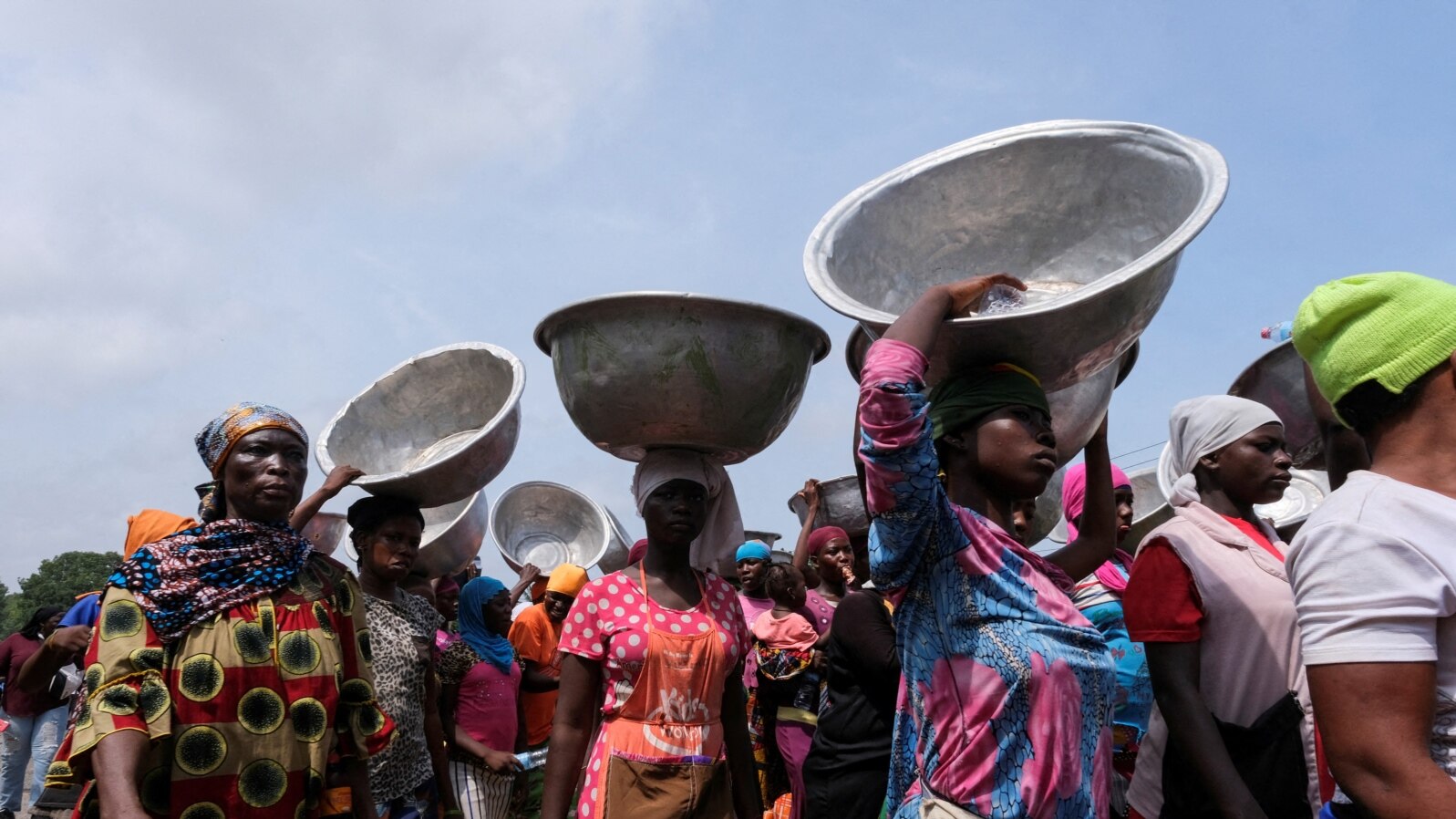 FILE - Head porters march in the streets to protests recent economic hardships, in Accra, Ghana, June 29, 2022.