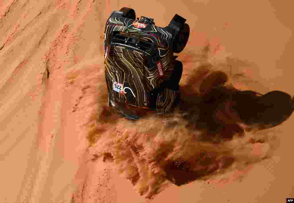 France's driver Guerlain Chicherit and co-driver Alex Winocq crash their buggy during Stage 4 of the Dakar 2022 between al-Qaysumah and Riyadh in Saudi Arabia, Jan. 5, 2022.