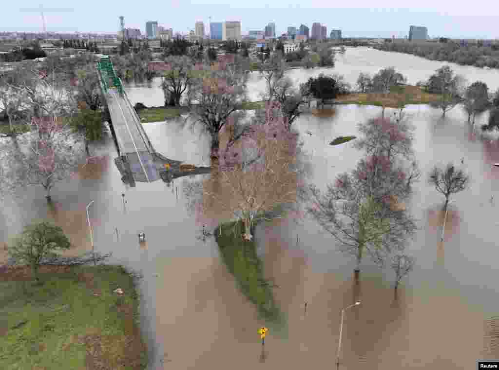 A view of flooding from the rainstorm-swollen Sacramento and American Rivers, near downtown Sacramento, California, Jan. 11, 2023.