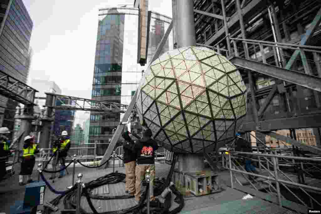 Workers install sparkling new Waterford Crystal triangles on the Times Square New Year's Eve Ball on the roof of One Times Square in Manhattan, New York City.