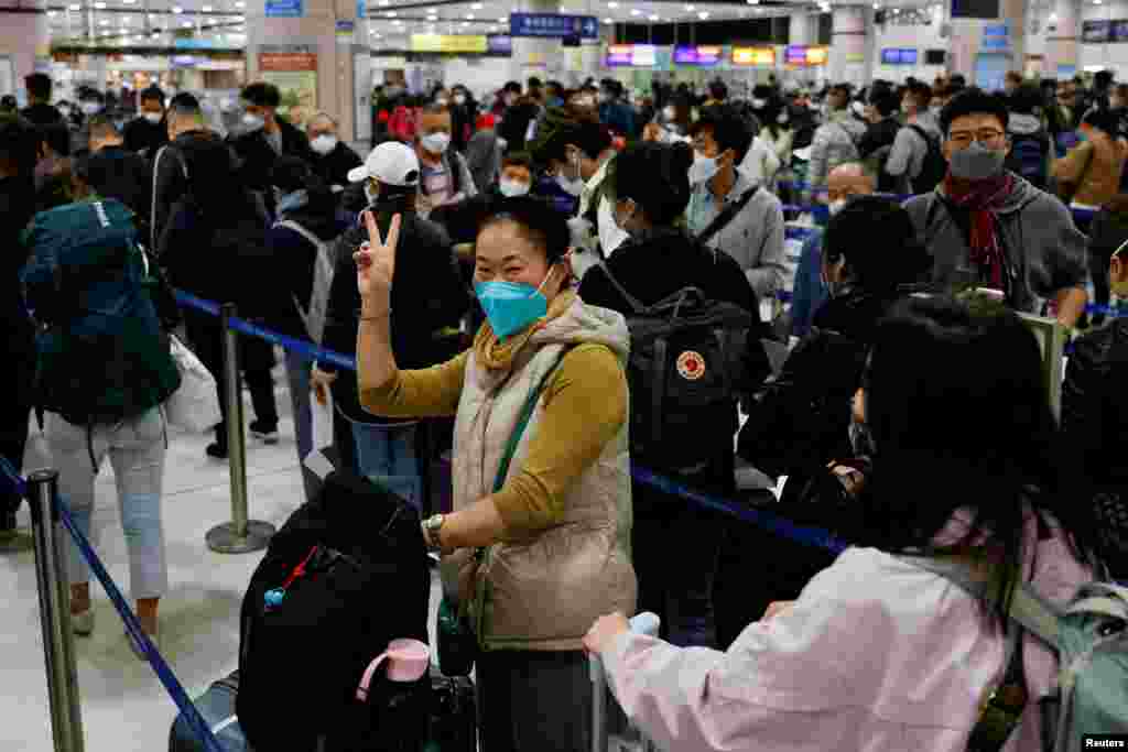 A woman celebrates at Hong Kong's Lok Ma Chau border checkpoint on the first day China reopens the border amid COVID-19 pandemic in Hong Kong.