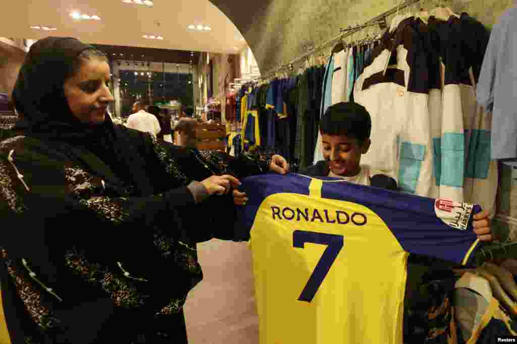 A fan holds up a Al Nassr jersey with Cristiano Ronaldo's name and number on the back in the Al Nassr club shop in Riyadh, Saudi Arabia. Portugal captain Cristiano Ronaldo has joined Saudi Arabian club Al Nassr, a month after the 37-year-old forward became a free agent when his contract with Premier League club Manchester United was terminated.