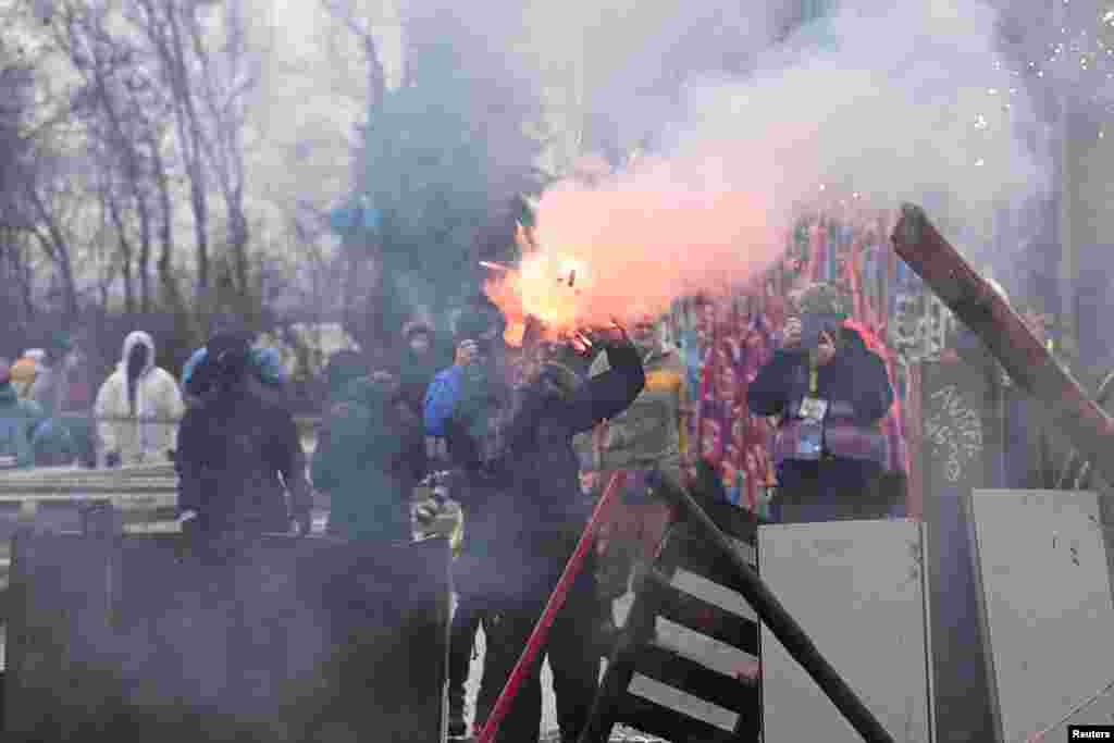 Demonstrators throw Molotow cocktails and fireworks at police officers, during a protest against the expansion of the Garzweiler open-cast lignite mine of Germany's utility RWE in Luetzerath, Germany.