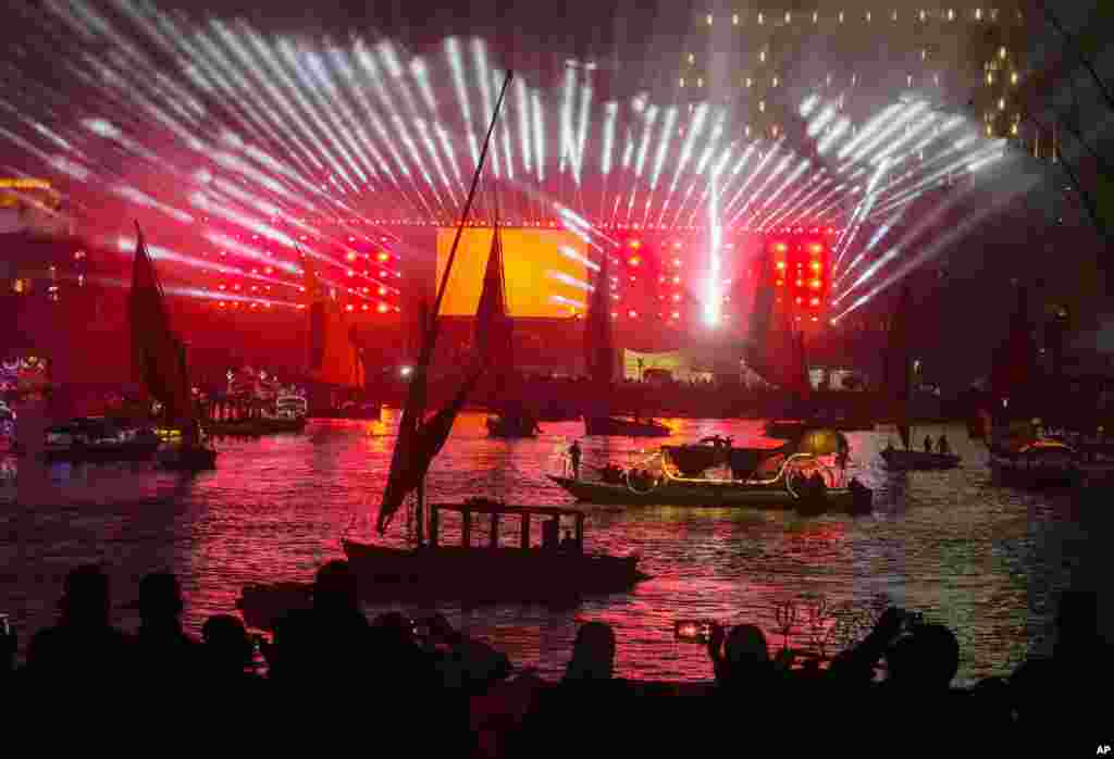 People take boat tours on the Nile River past New Year decorations as celebrations begin in Cairo, Egypt, Jan. 1, 2023.