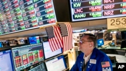 FILE - Trader Patrick King works the floor at the New York Stock Exchange, Thursday, May 12, 2022, in New York.
