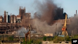 FILE - Smoke rises from the Metallurgical Combine Azovstal in Mariupol during shelling, in Mariupol, in eastern Ukraine, May 7, 2022.