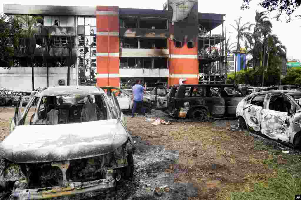 A man walks outside the Santa Cruz departmental prosecutor's office that was set on fire overnight, in Santa Cruz, Bolivia.