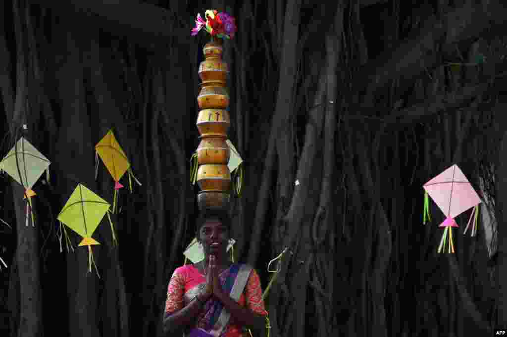 A students performs a Karagattam folk dance during celebrations for 'Pongal', the Tamil harvest festival, at a college in Chennai, India.