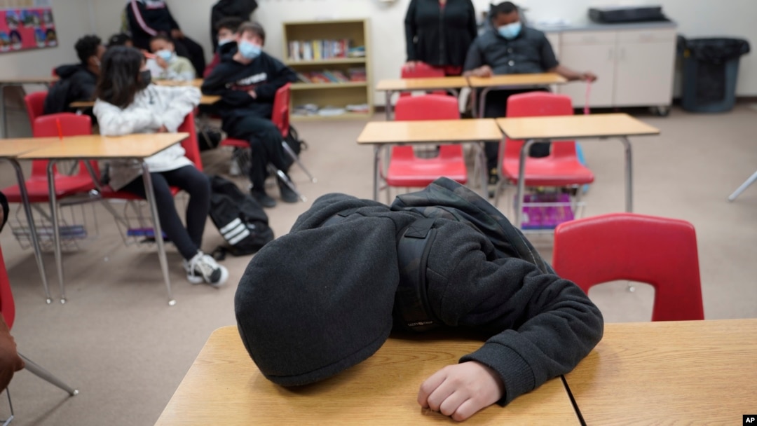 An unidentified student rests on his desk as the Mojave Unified School District. (AP Photo/Damian Dovarganes)