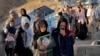 The family of a victim of a suicide bombing on a Hazara education center, goes to her grave for a mourning ceremony, in Kabul, Afghanistan, Oct. 2, 2022.