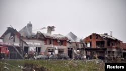 Firefighters work at the site of military strikes on buildings as Russia's attack on Ukraine continues, in Lviv, Ukraine April 18, 2022.